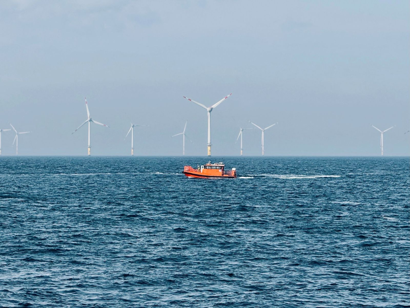 Crew transfer vessel underway within an offshore wind farm